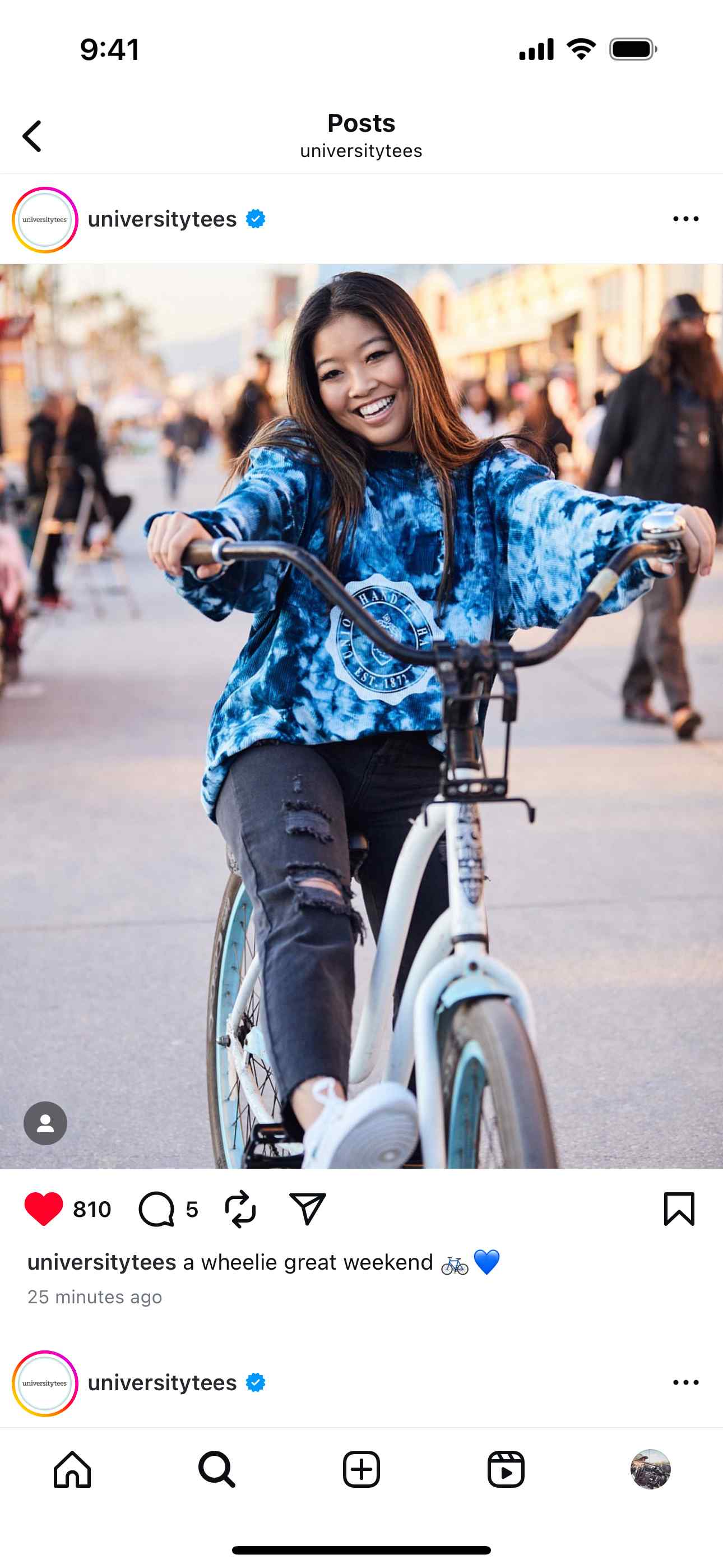 Instagram post by University Tees featuring a lifestyle campaign photo of a young woman riding a bike on the Venice Beach boardwalk, wearing a blue tie-dye hoodie. The caption reads, "a wheelie great weekend" with a bicycle and heart emoji.