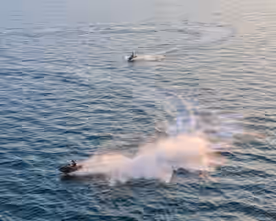 Aerial view of jet skiers in open ocean at sunset near Tallinn, Estonia