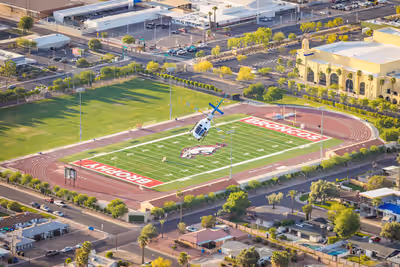 Law enforcement H125 helicopter banking over Phoenix high school during morning patrol