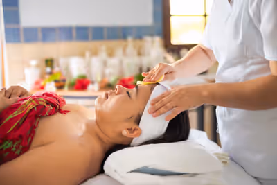 Woman getting facial treatment in spa room at Chaa Creek resort in Belize