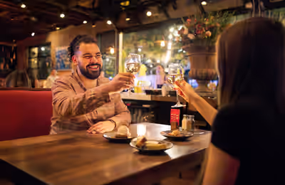 Couple toasting wine over dessert at Postino Annex in Tempe