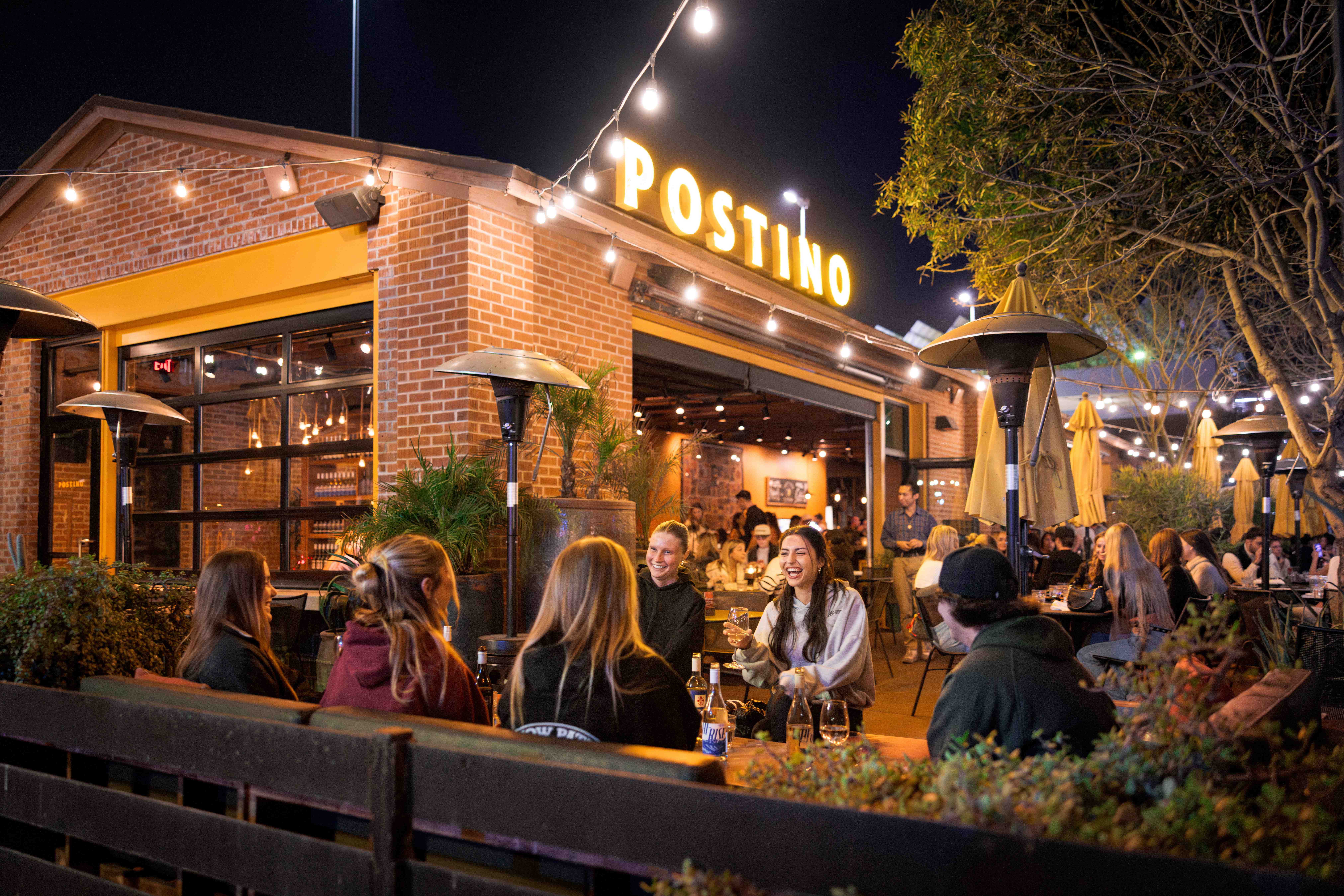 Group of friends enjoying wine and bruschetta boards at Postino Annex in Tempe