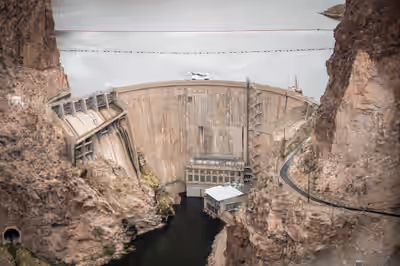 Bell 429 helicopter landing on Horse Mesa Dam helipad in Arizona canyon