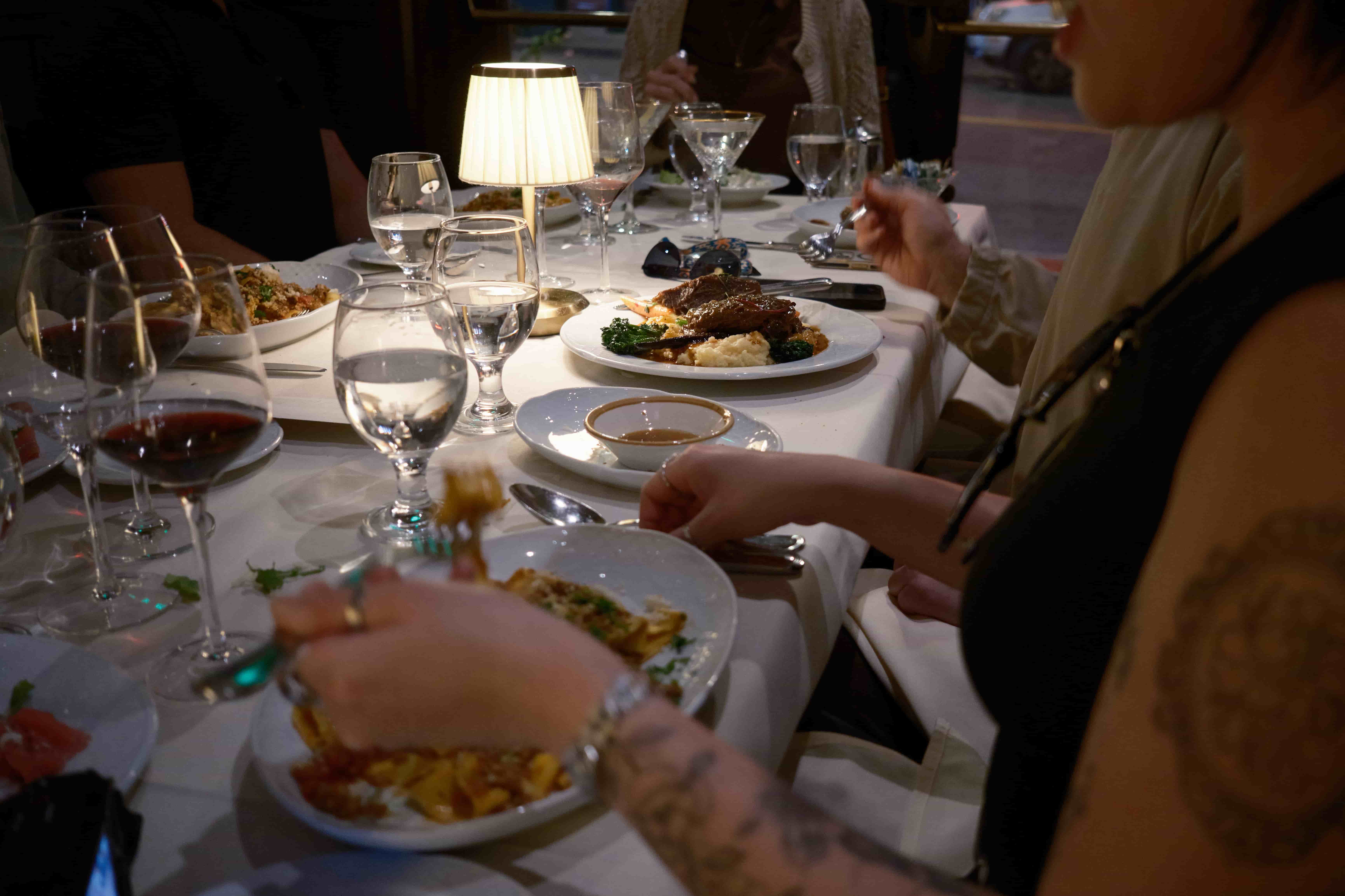 Italian dinner at North Beach Restaurant, San Francisco, California Diner's view across an Italian dinner table with wine glasses and warm lamp light