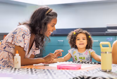 Mother and daughter smiling while doing crafts together in Tempe, Arizona