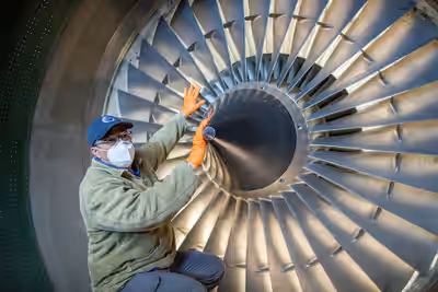 Technician inspects RB211 turbofan engine fan blades on L-1011 Stargazer at Edwards AFB