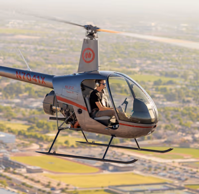 Student solo pilot flying Robinson R22 helicopter over Chandler, Arizona during training
