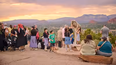 Families gathered at Sedona Airport Scenic Lookout overlooking red rocks at sunset